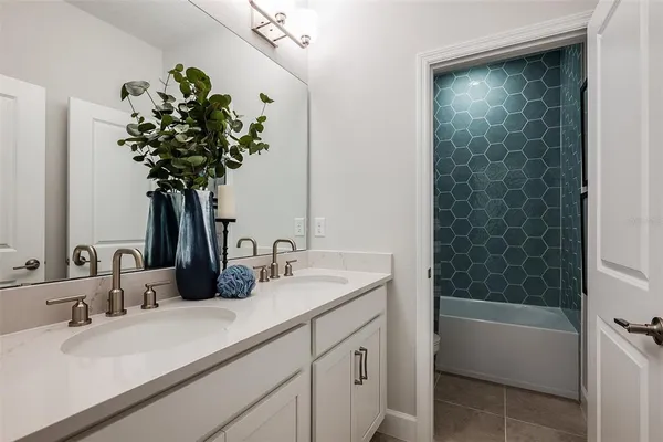 a bathroom with a sink a vanity and a bathtub