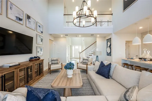 a living room with furniture kitchen view and a flat screen tv