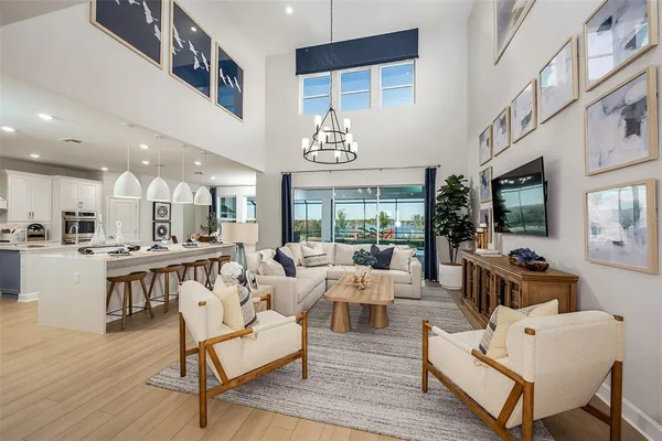 a living room with fireplace furniture and a large window