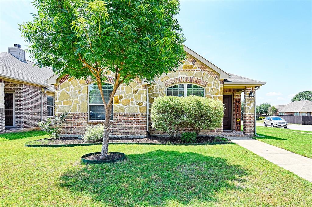a front view of house with yard and green space