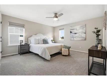 a bedroom with a bed a table and chair