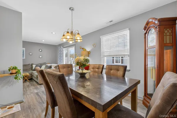 a view of a dining room with furniture and chandelier