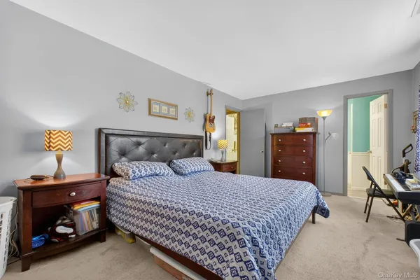 a bedroom with a bed and a lamp