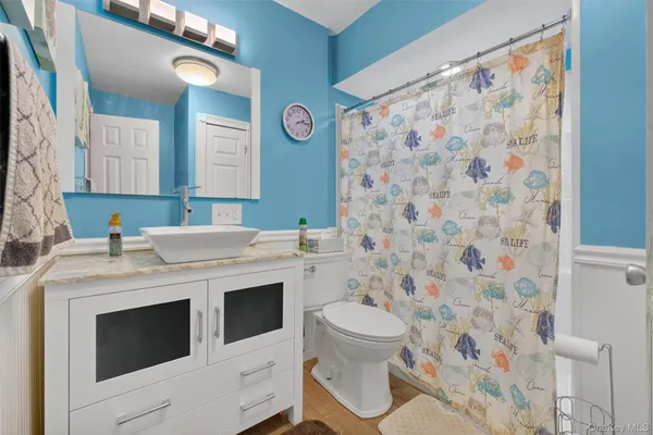 a bathroom with a sink toilet and shower