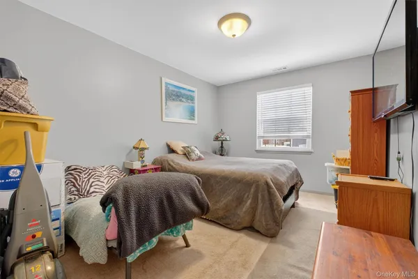 a bedroom with bed and a window