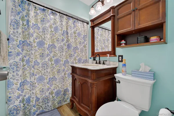 a bathroom with a toilet sink and mirror