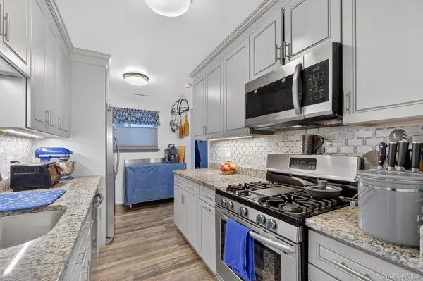 a kitchen with stainless steel appliances granite countertop a stove and a sink