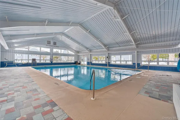 a swimming pool with an outdoor seating