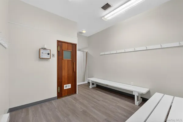 a view of a room with wooden floor and white walls