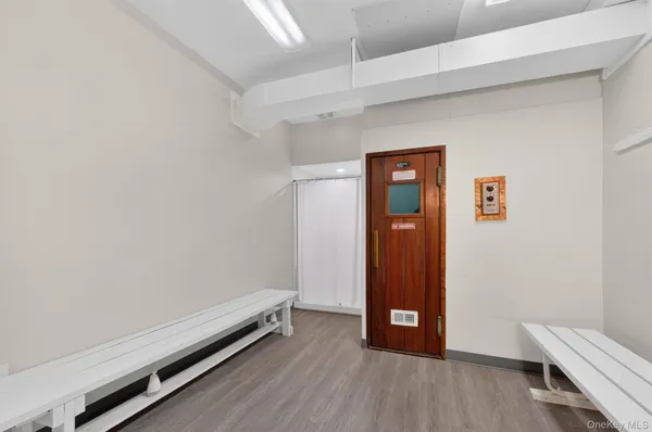 an empty room with wooden floor and closet