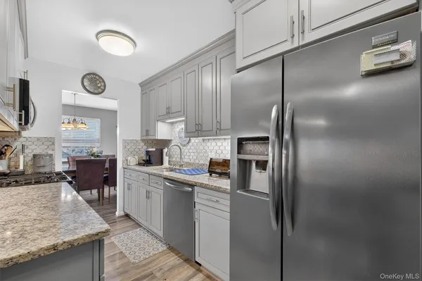 a kitchen with a refrigerator a sink and a stove