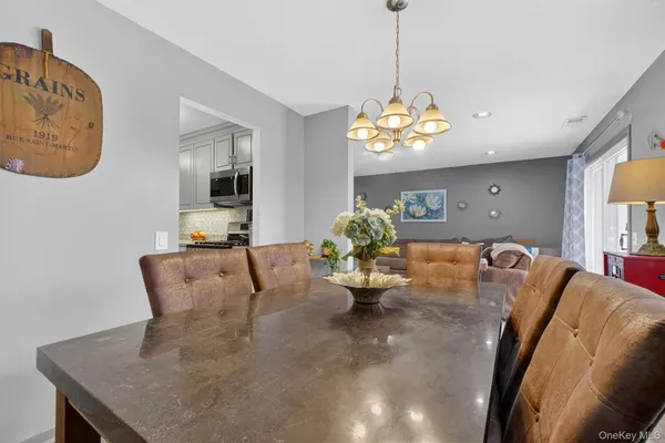 a living room with furniture chandelier and a window