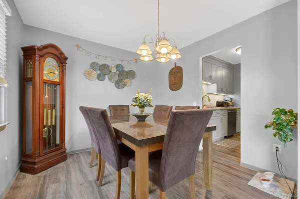 a view of a dining room with furniture wooden floor and a chandelier