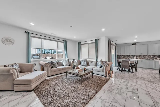 a living room with furniture potted plant and a table