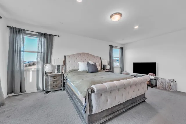 a bedroom with a bed and a tv