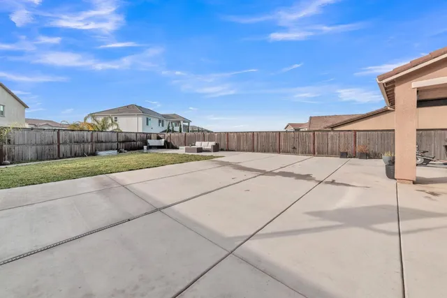 a view of a green field with wooden fence