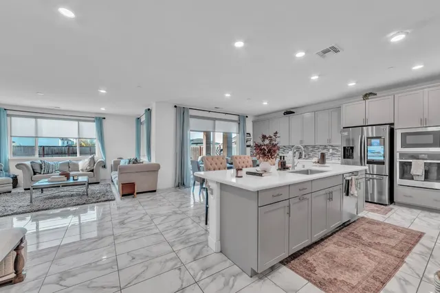 a large white kitchen with a large window
