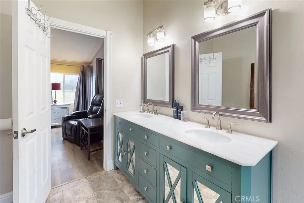 3453 La Porte Road Oroville, CA 95966 - Photo 28 of 69 a en suite bathroom with a double vanity sink a mirror and a shower