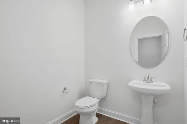 a bathroom with a sink toilet and a mirror
