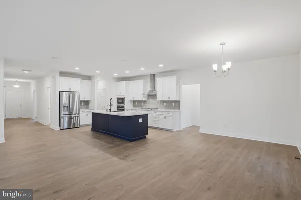a view of kitchen with kitchen island and stainless steel appliances