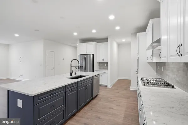 a kitchen with stainless steel appliances granite countertop a sink and cabinets
