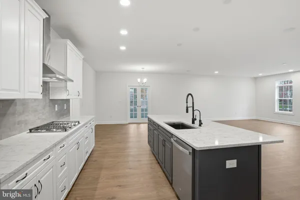 a kitchen with sink stove and cabinets