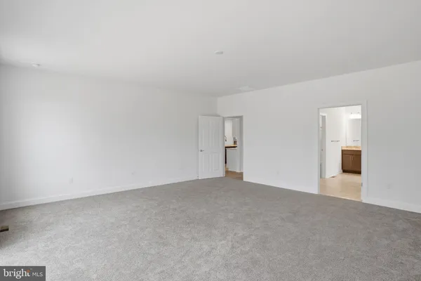 a view of an empty room with chandelier