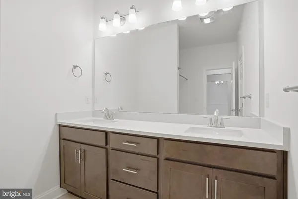 a bathroom with a sink double vanity and a mirror