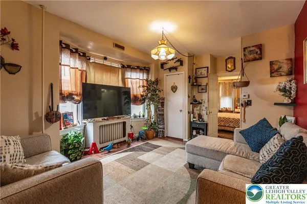 a living room with furniture and a flat screen tv