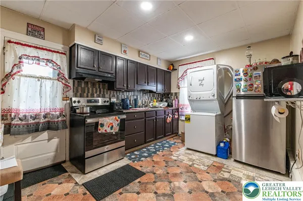 a kitchen with refrigerator and cabinets