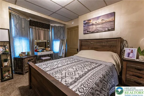 a bed sitting in a bedroom next to a window