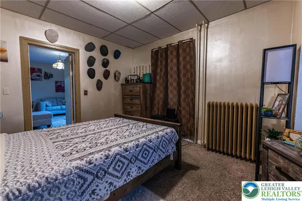a bedroom with a bed and a mirror