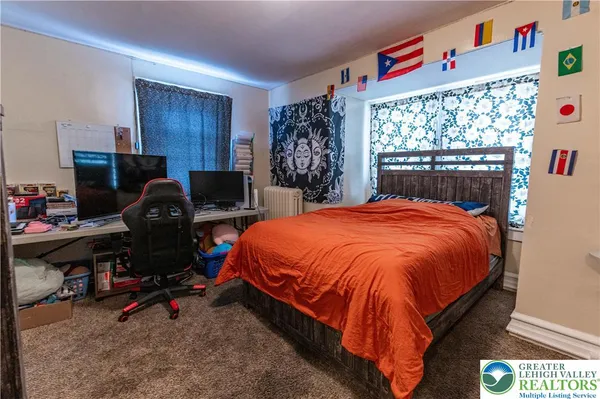a bed sitting in a bedroom next to a window