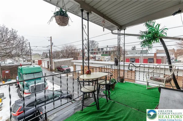 a view of a chairs and table in patio with a yard