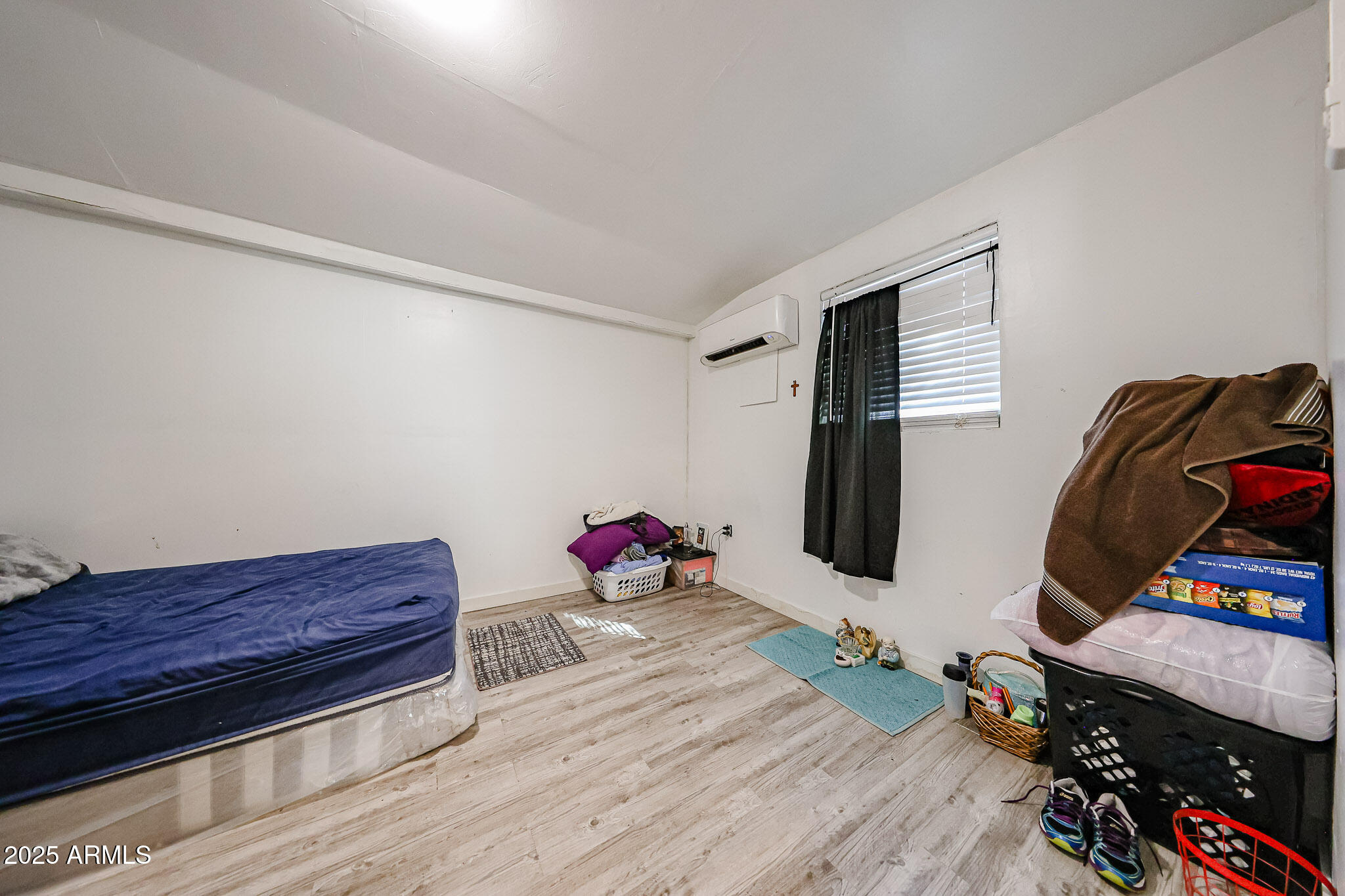 8223 C. Azteca Guadalupe, AZ 85283 - Photo 14 of 24 a room with wooden floor and gym equipment