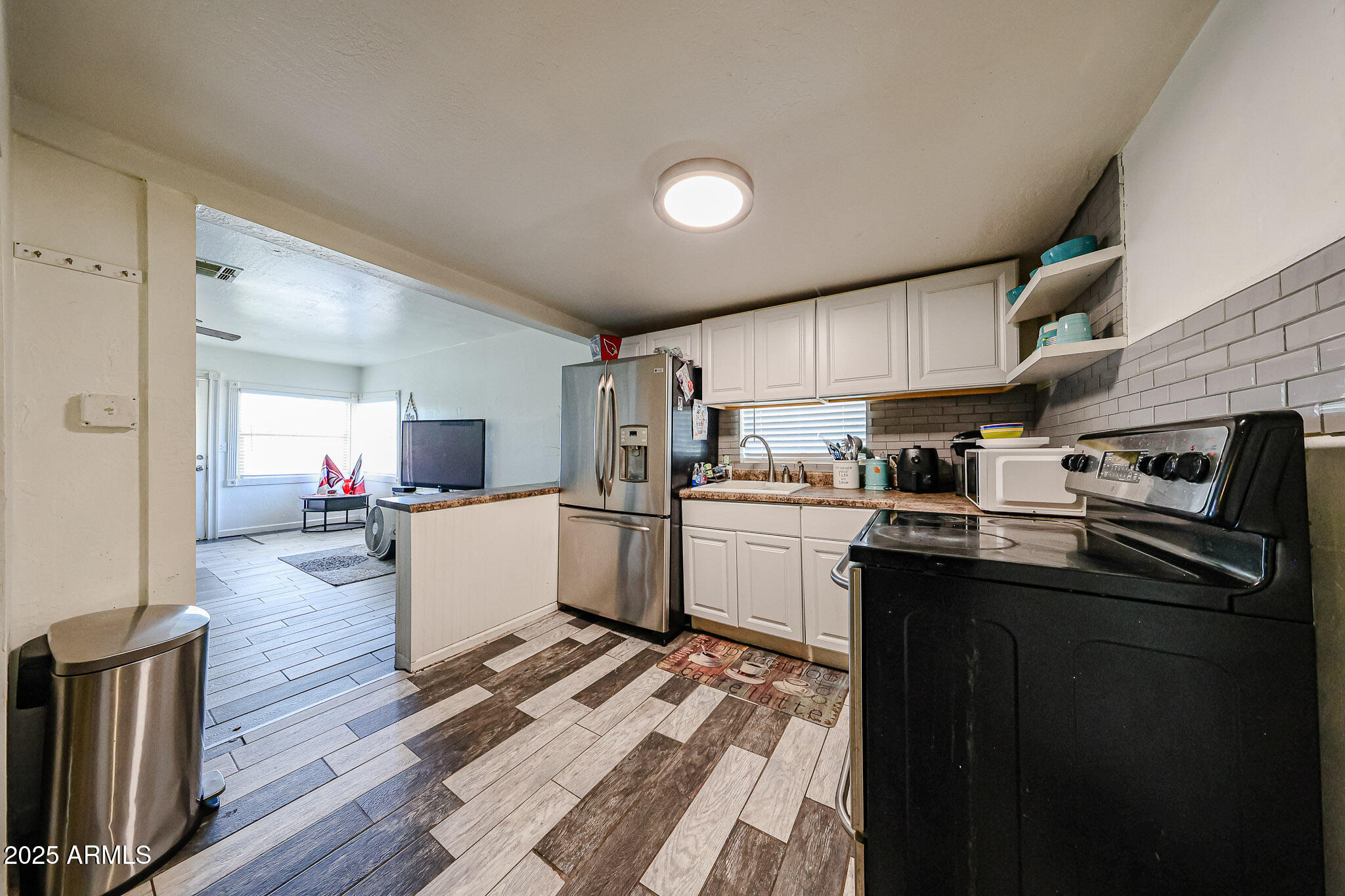 8223 C. Azteca Guadalupe, AZ 85283 - Photo 7 of 24 a kitchen with sink refrigerator and cabinets