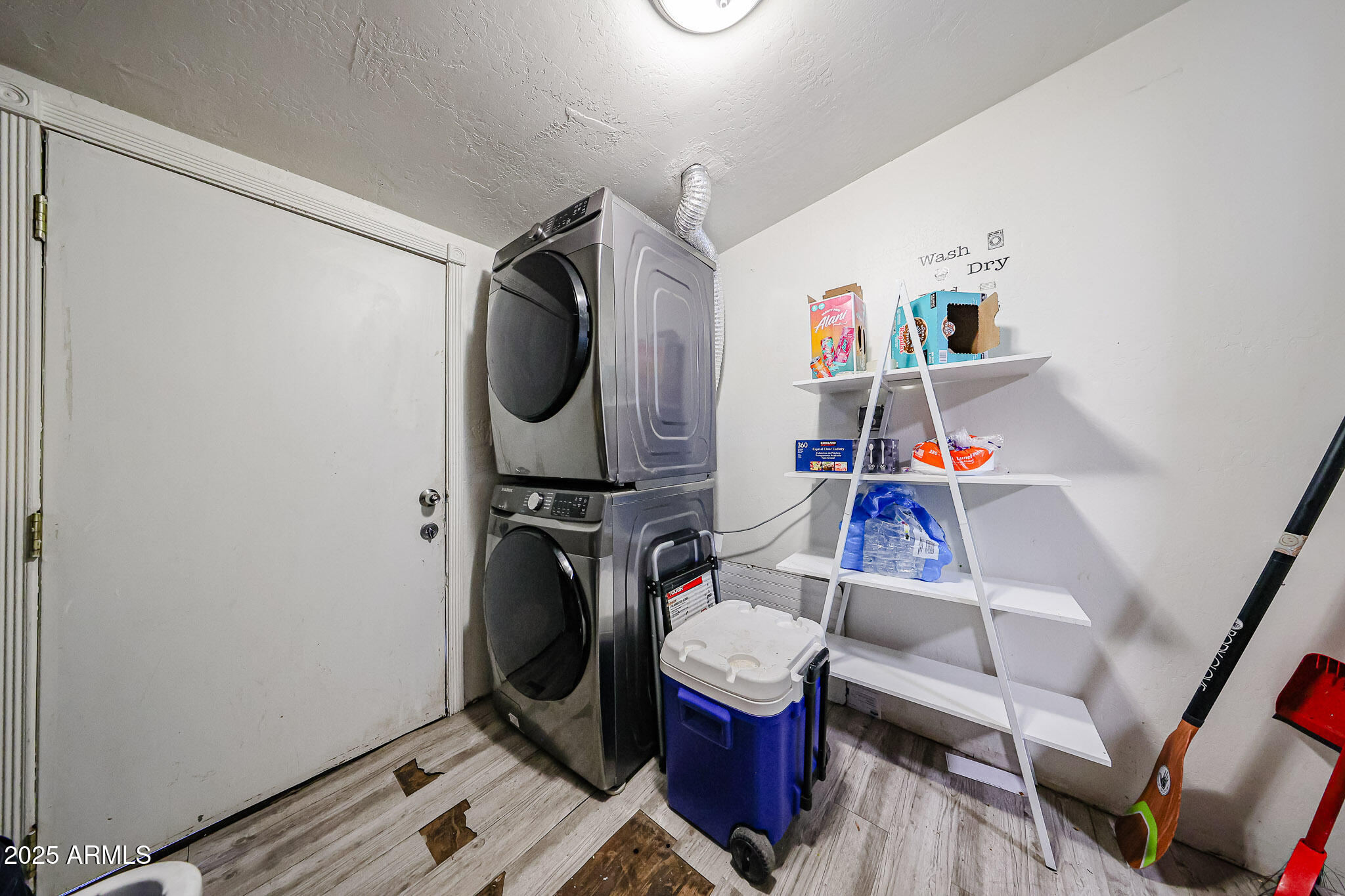8223 C. Azteca Guadalupe, AZ 85283 - Photo 9 of 24 a utility room with dryer washer and a view of living room