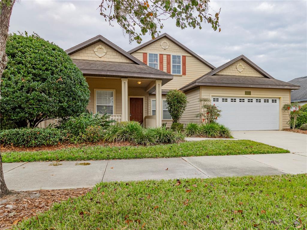 8436 Southwest 77th Avenue Gainesville, FL 32608 - Photo 1 of 21 a front view of a house with a yard and garage