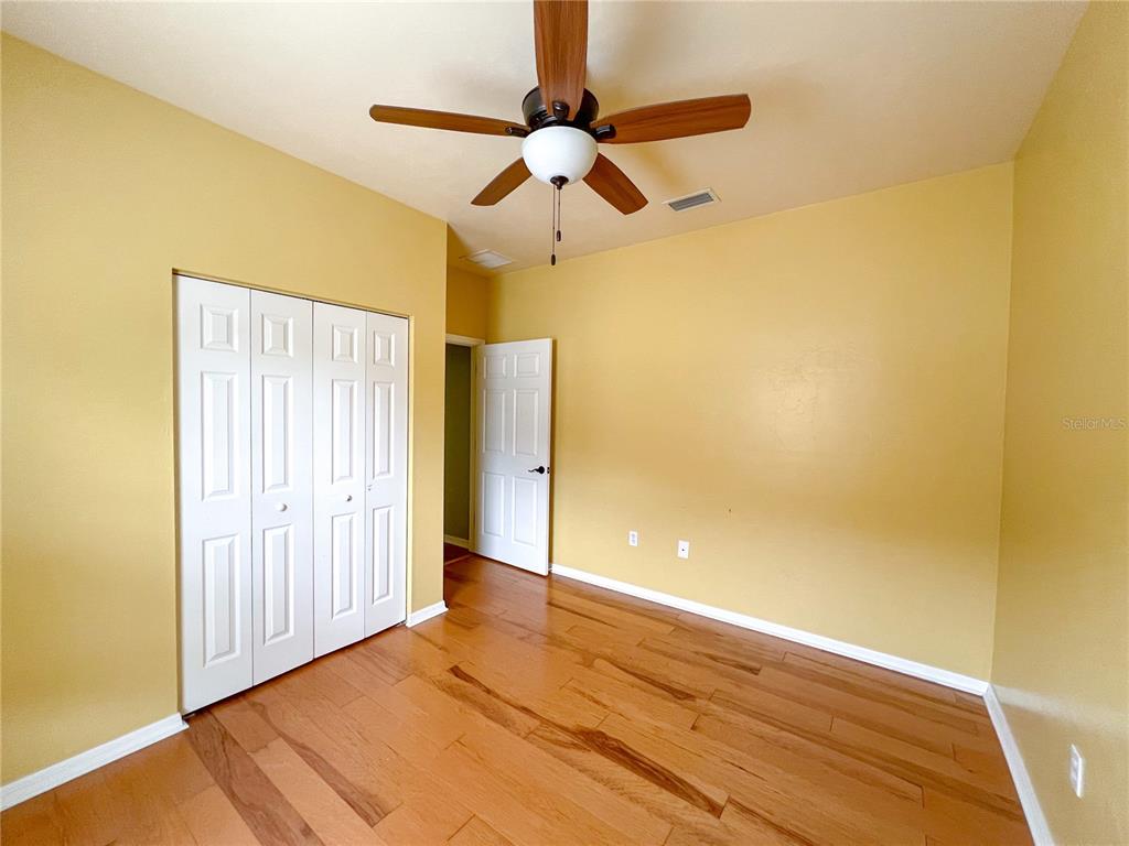 8436 Southwest 77th Avenue Gainesville, FL 32608 - Photo 18 of 21 a view of an empty room with window and wooden floor