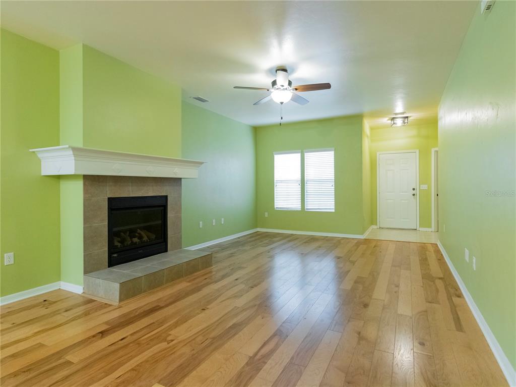 8436 Southwest 77th Avenue Gainesville, FL 32608 - Photo 4 of 21 a view of an empty room with a fireplace and a window
