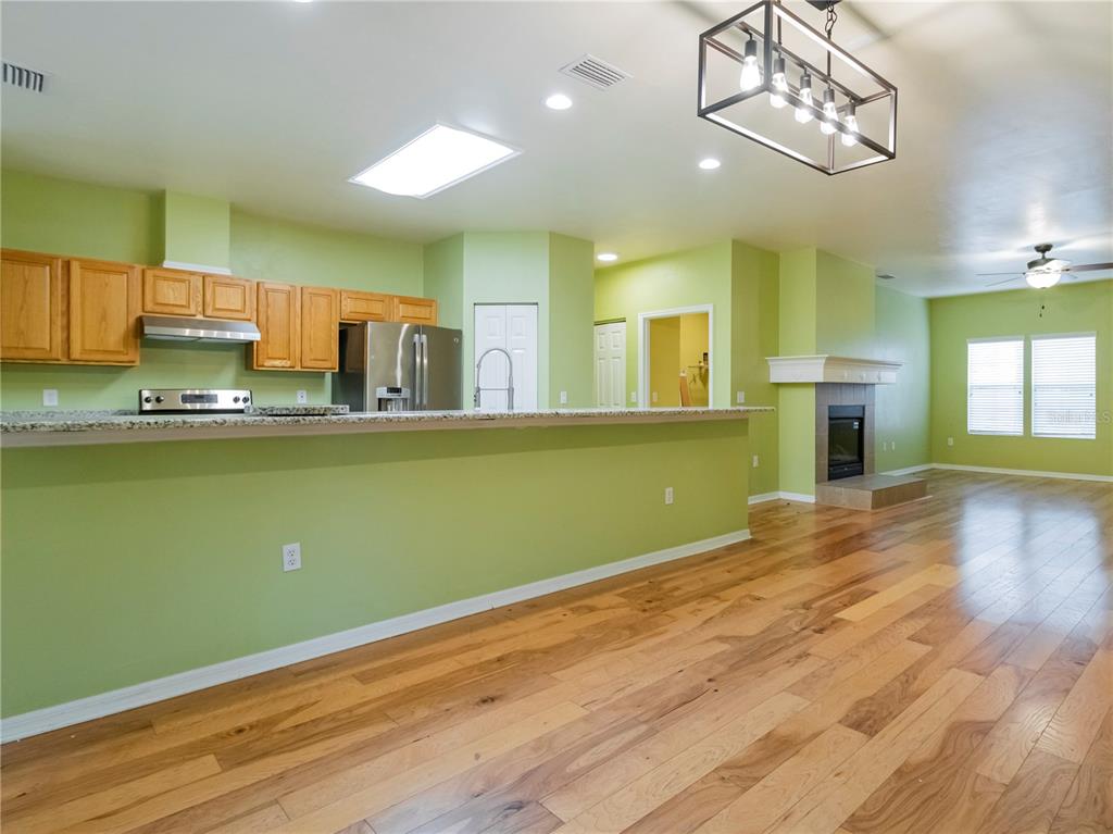 8436 Southwest 77th Avenue Gainesville, FL 32608 - Photo 7 of 21 a view of a kitchen with kitchen island a sink wooden floor and a window