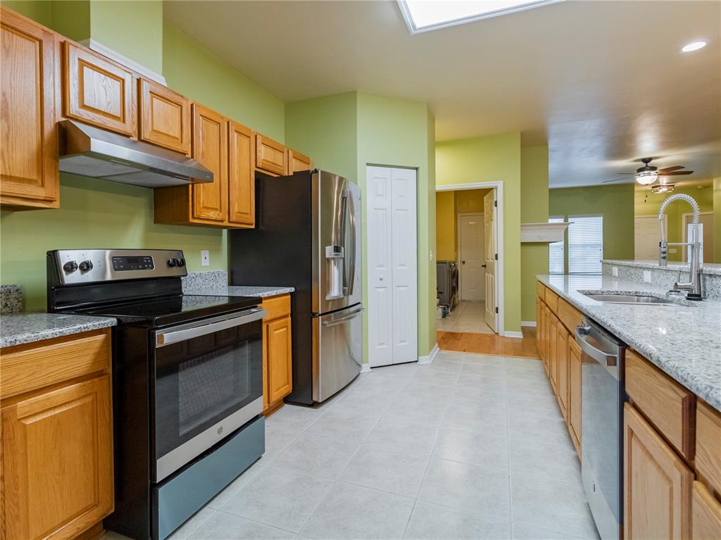 8436 Southwest 77th Avenue Gainesville, FL 32608 - Photo 8 of 21 a kitchen with stainless steel appliances granite countertop a stove a sink and a refrigerator
