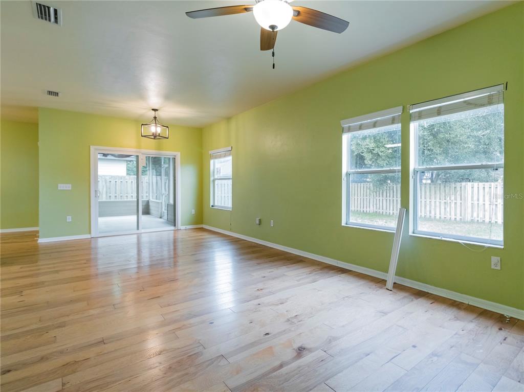 8436 Southwest 77th Avenue Gainesville, FL 32608 - Photo 10 of 21 a view of an empty room with window and wooden floor