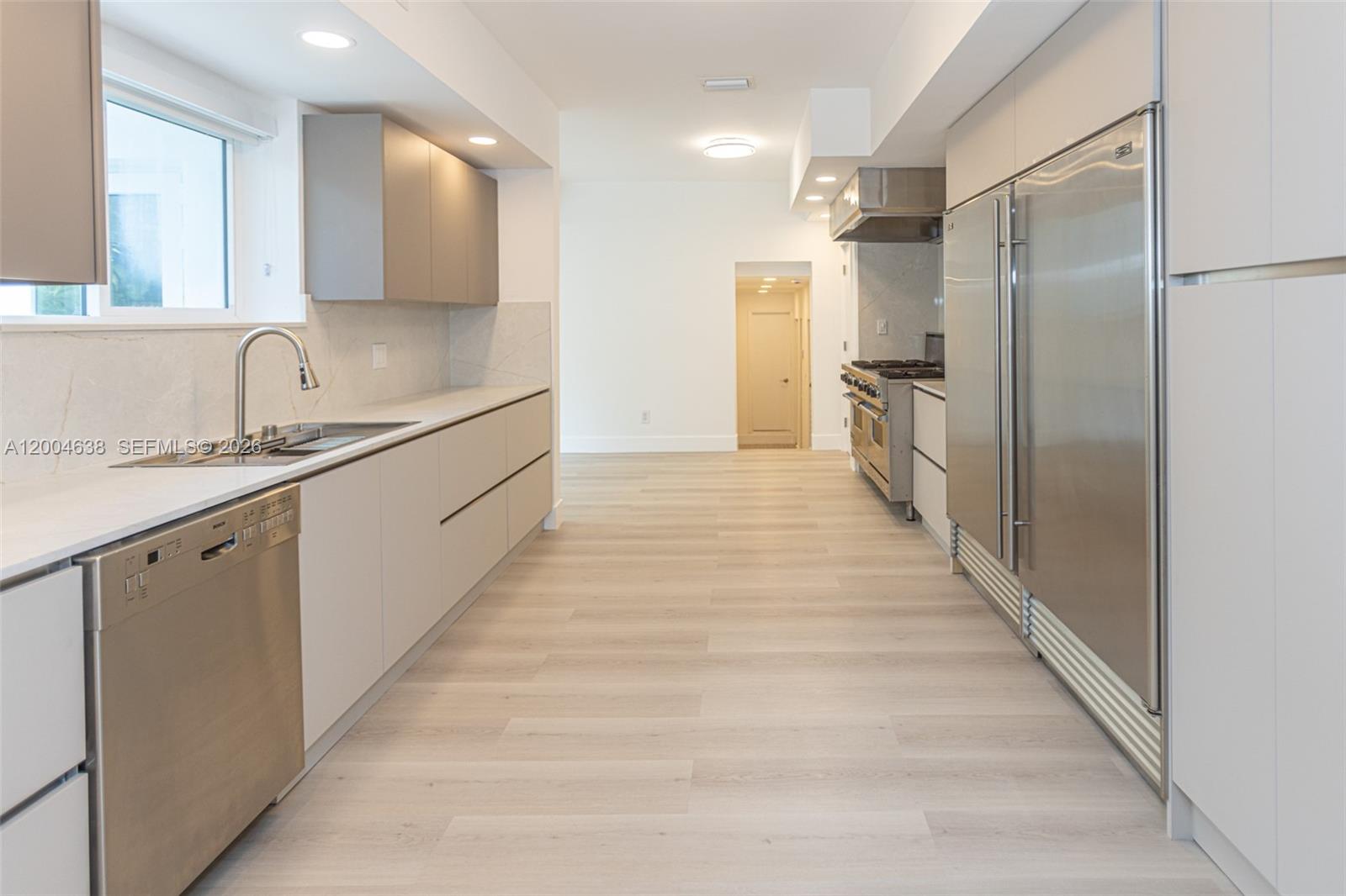 1690 Daytonia Road Miami Beach, FL 33141 - Photo 2 of 88 a large kitchen with a sink and refrigerator