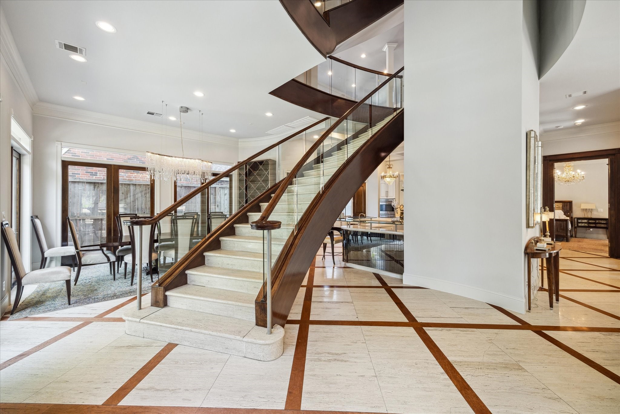 2247 Bartlett Street Houston, TX 77098 - Photo 4 of 50 FRONT ENTRY with sweeping staircase and inlaid wood and stone floors.