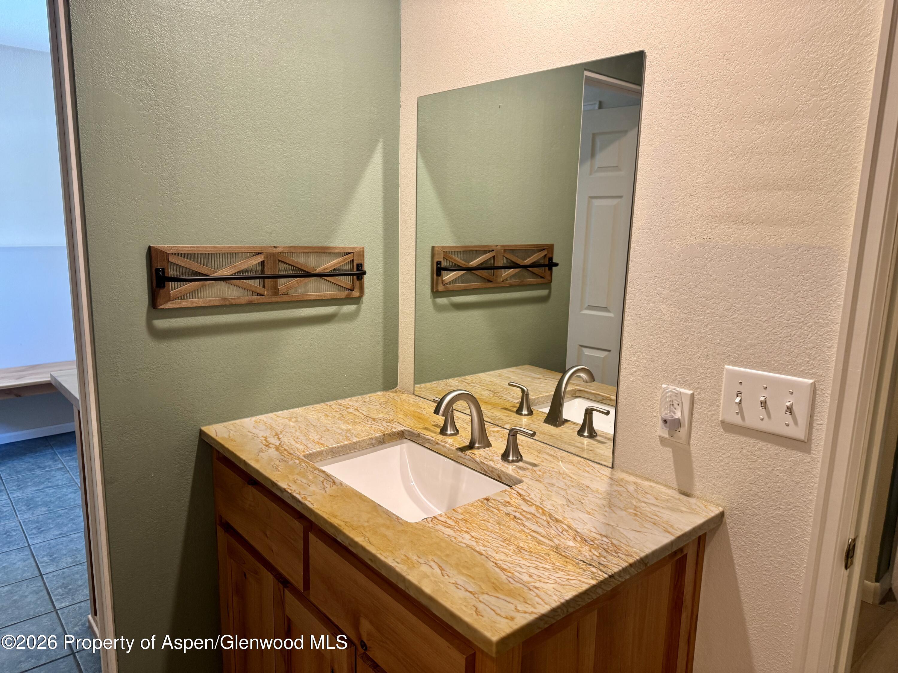 1287 Market Street Meeker, CO 81641 - Photo 15 of 42 a bathroom with a sink and mirror