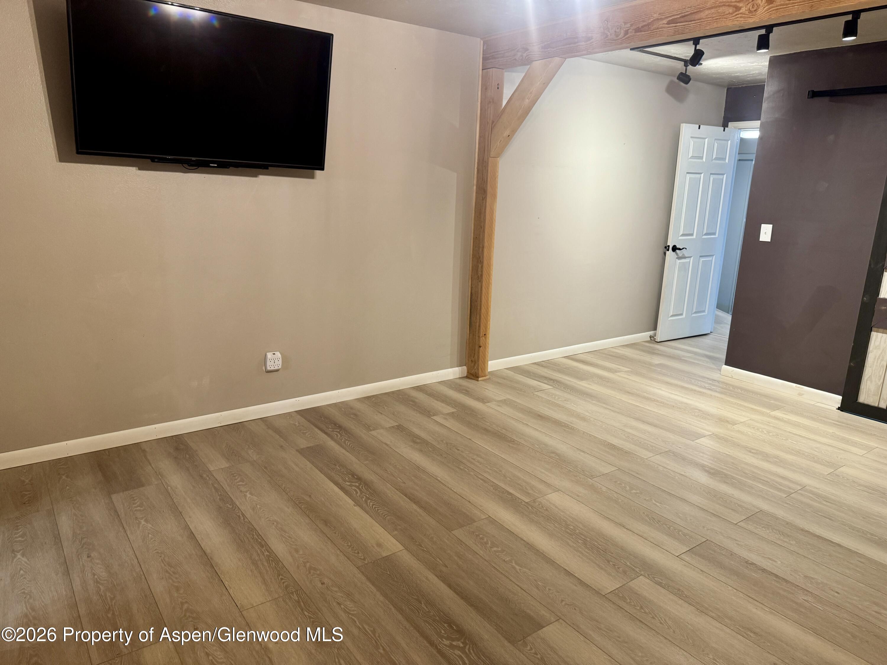 1287 Market Street Meeker, CO 81641 - Photo 22 of 44 a view of a livingroom with an empty space and a flat screen tv