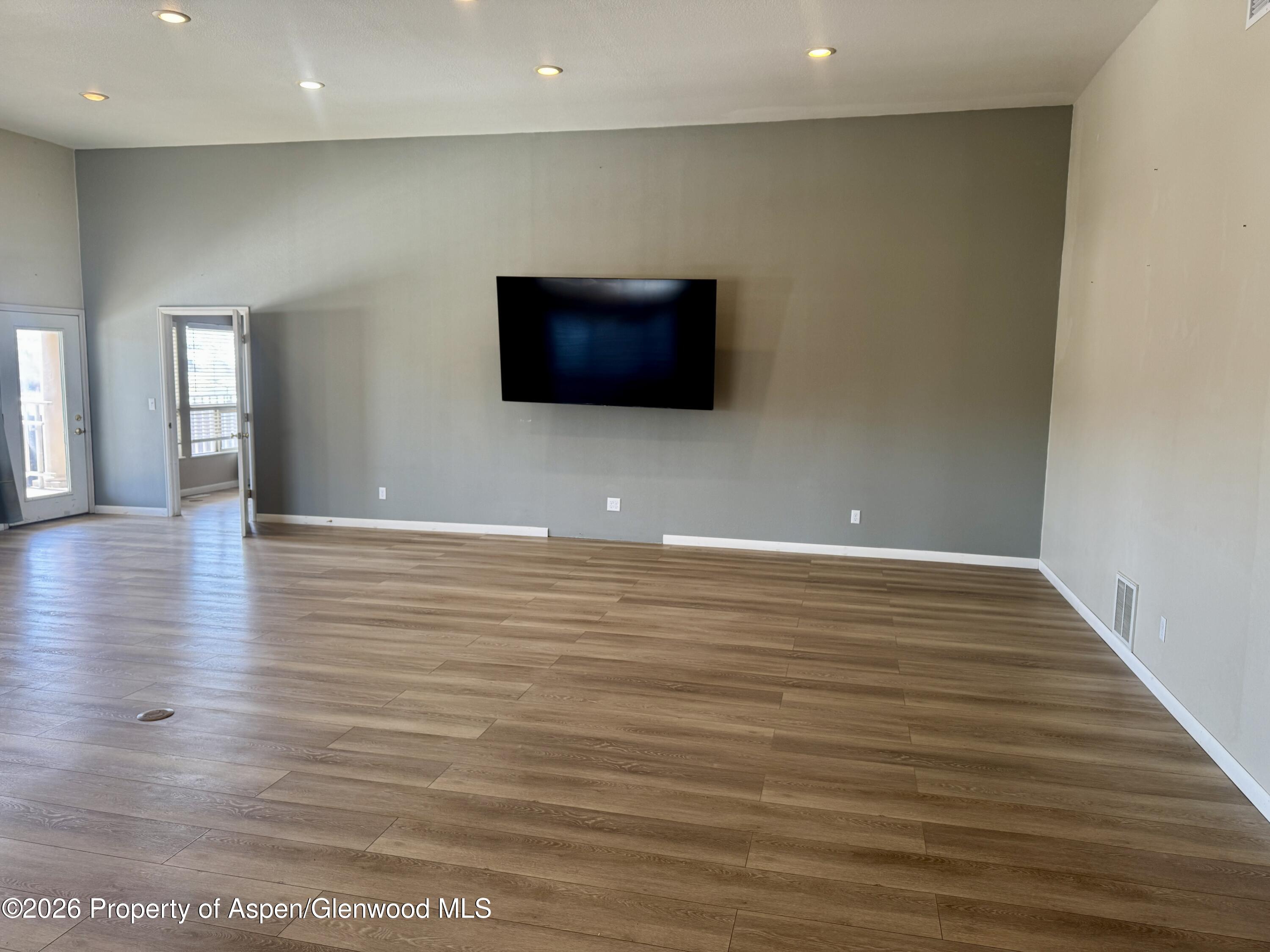 1287 Market Street Meeker, CO 81641 - Photo 5 of 42 a view of an empty room with wooden floor and a window