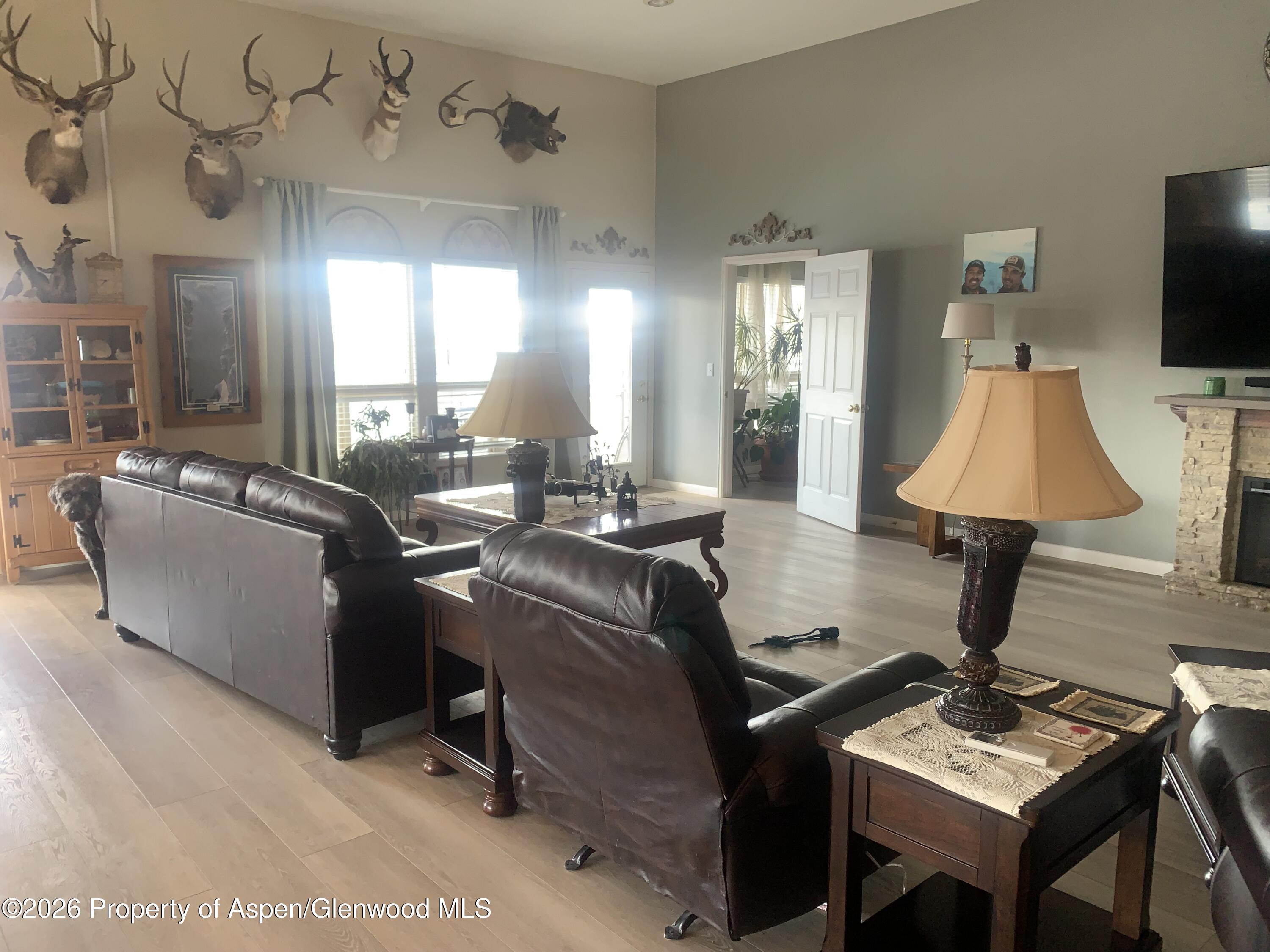 1287 Market Street Meeker, CO 81641 - Photo 8 of 44 a living room with furniture a lamp and a flat screen tv