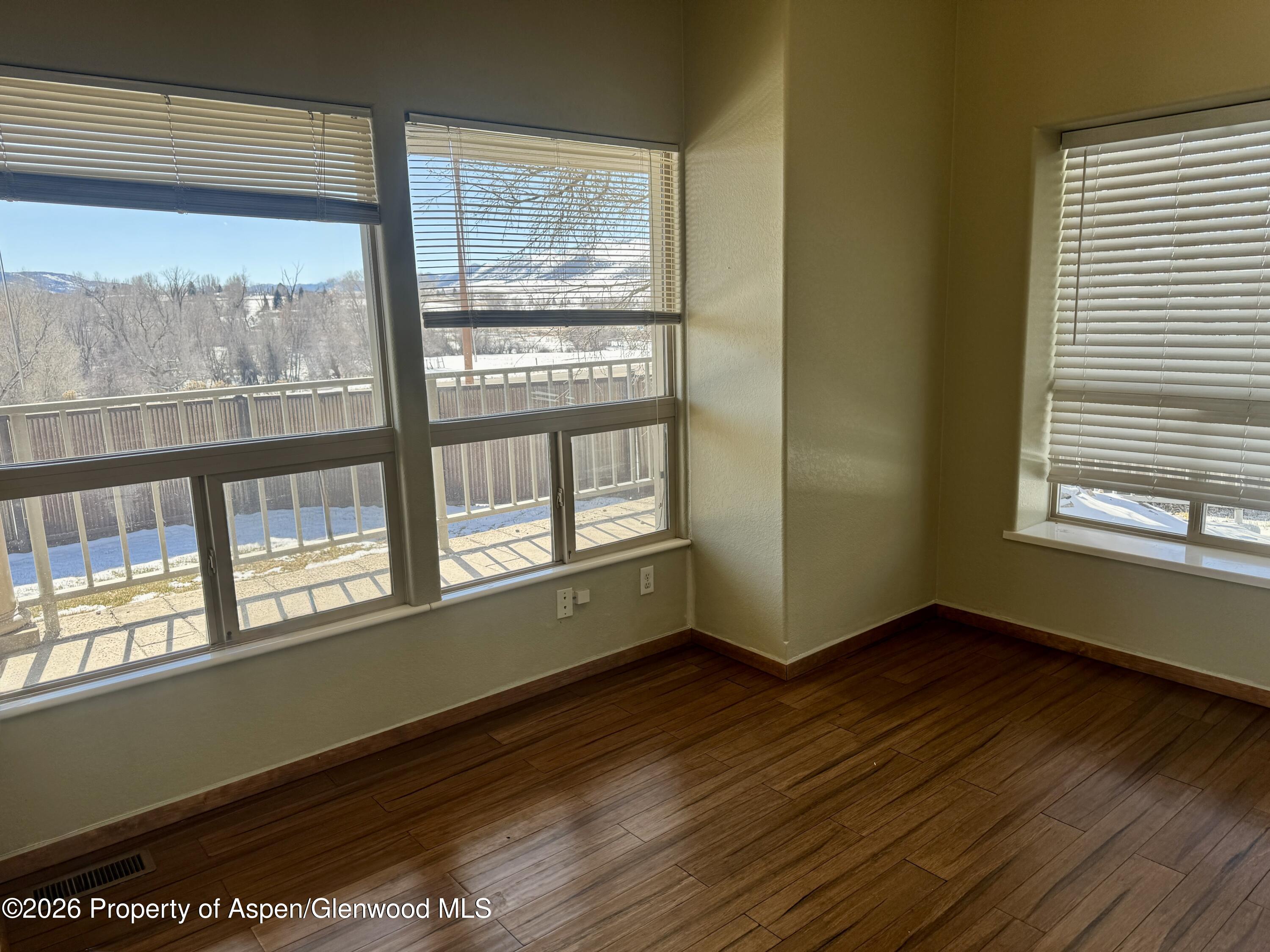 1287 Market Street Meeker, CO 81641 - Photo 10 of 44 a view of an empty room with wooden floor and a window